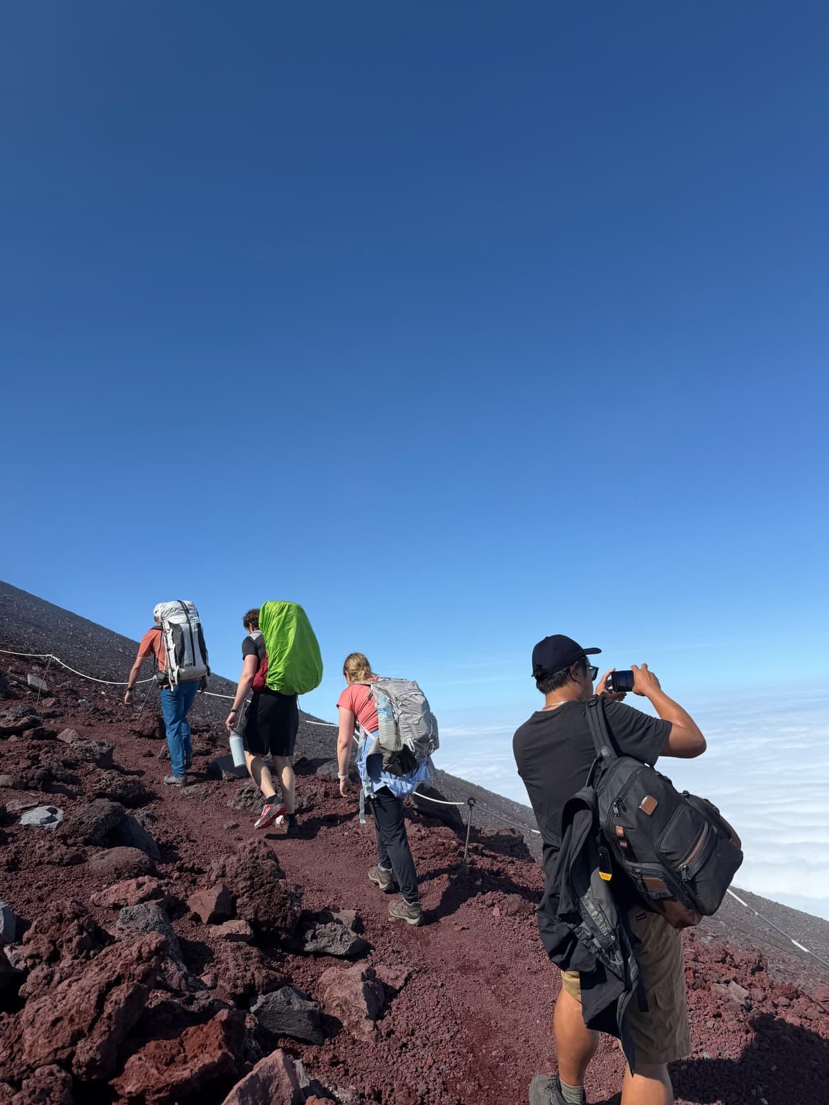 Climbing Mt. Fuji above a sea of clouds