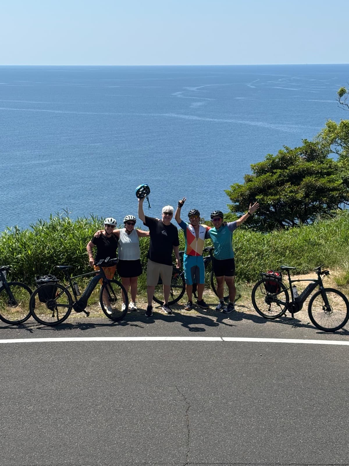 Guests cheering above the deep blue sea