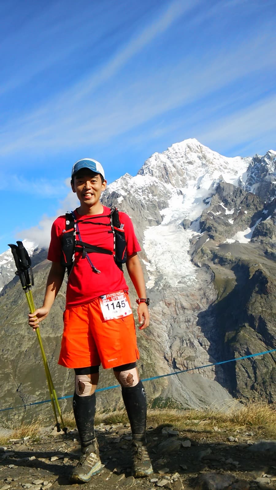 Masa running UTMB with the Mont Blanc massif behind